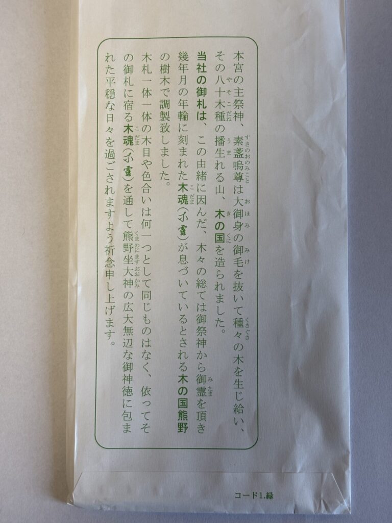木の御札、「木魂」(こだま)の包み紙の裏面。 木魂の説明文が書かれている。