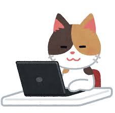 パソコンを打っている猫の画像